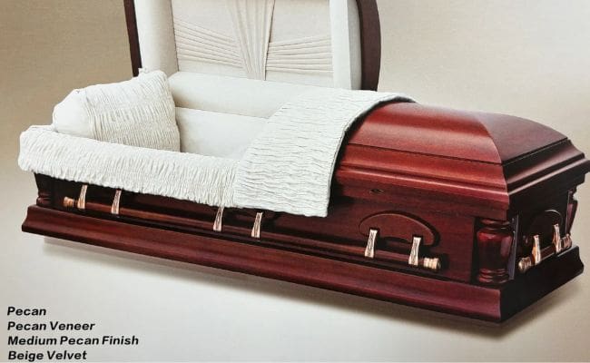 A closed wooden coffin with white interior lining.