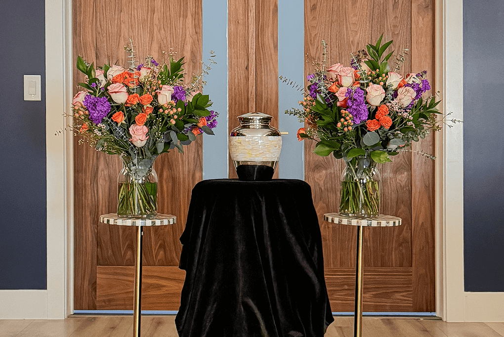 A family holding an urn after cremation services.